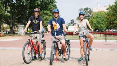 Three people pose for a photo on their bikes in Washington, D.C.