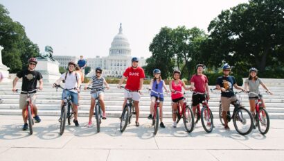 A group poses with their bikes in front of the Capitol in Washington, D.C.