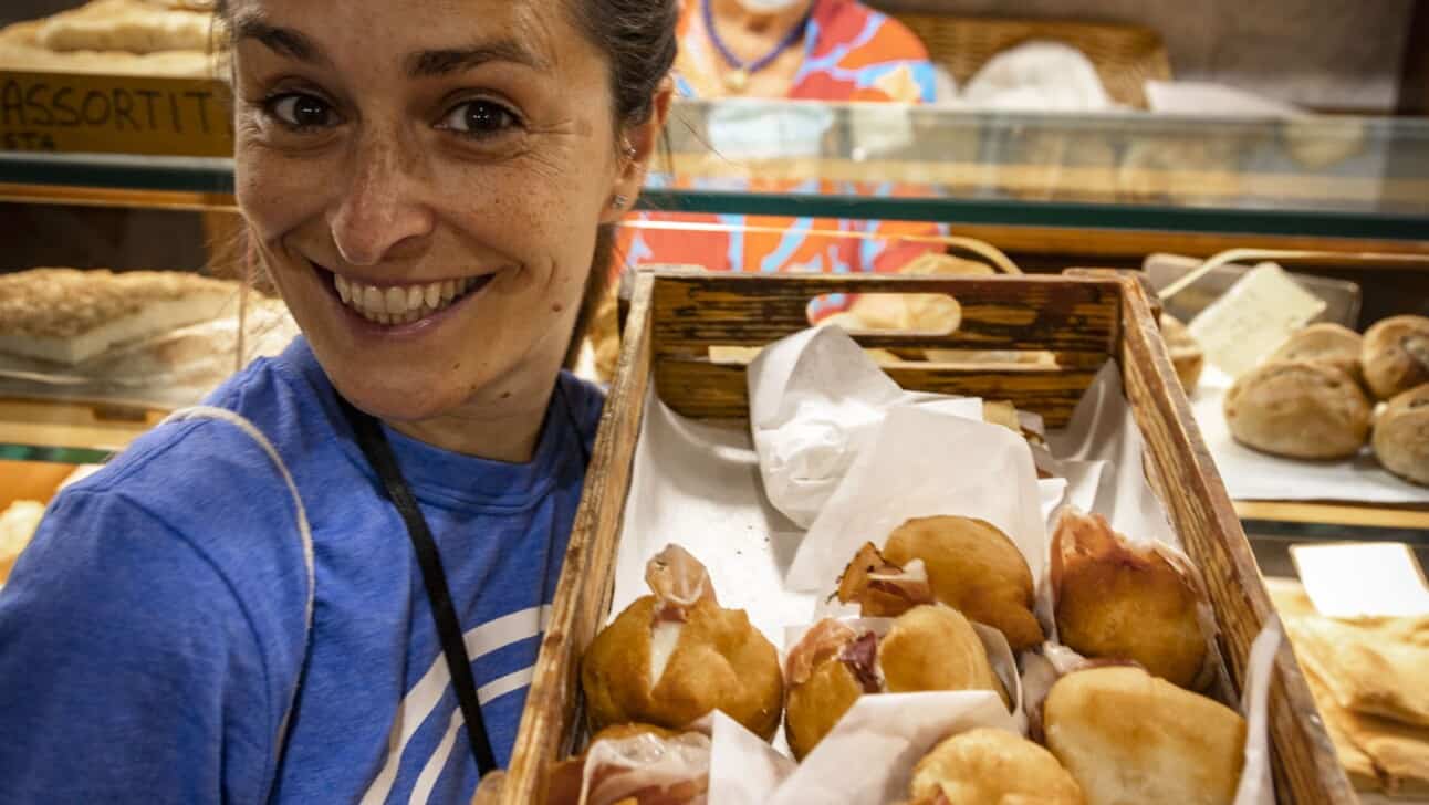 A guide holds up a basket of coccolo in Florence, Italy