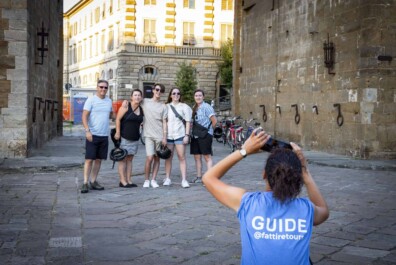 The guide takes a photo of a group in Florence, Italy