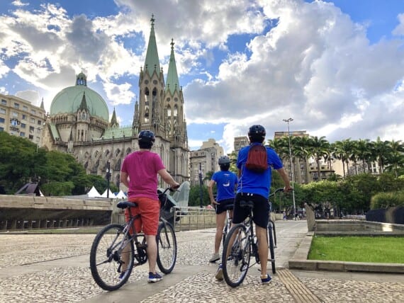 3 bike riders enjoy the view of the cathedral in Sao Paulo