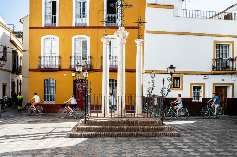 A group of tourists enjoy a bike tour in seville
