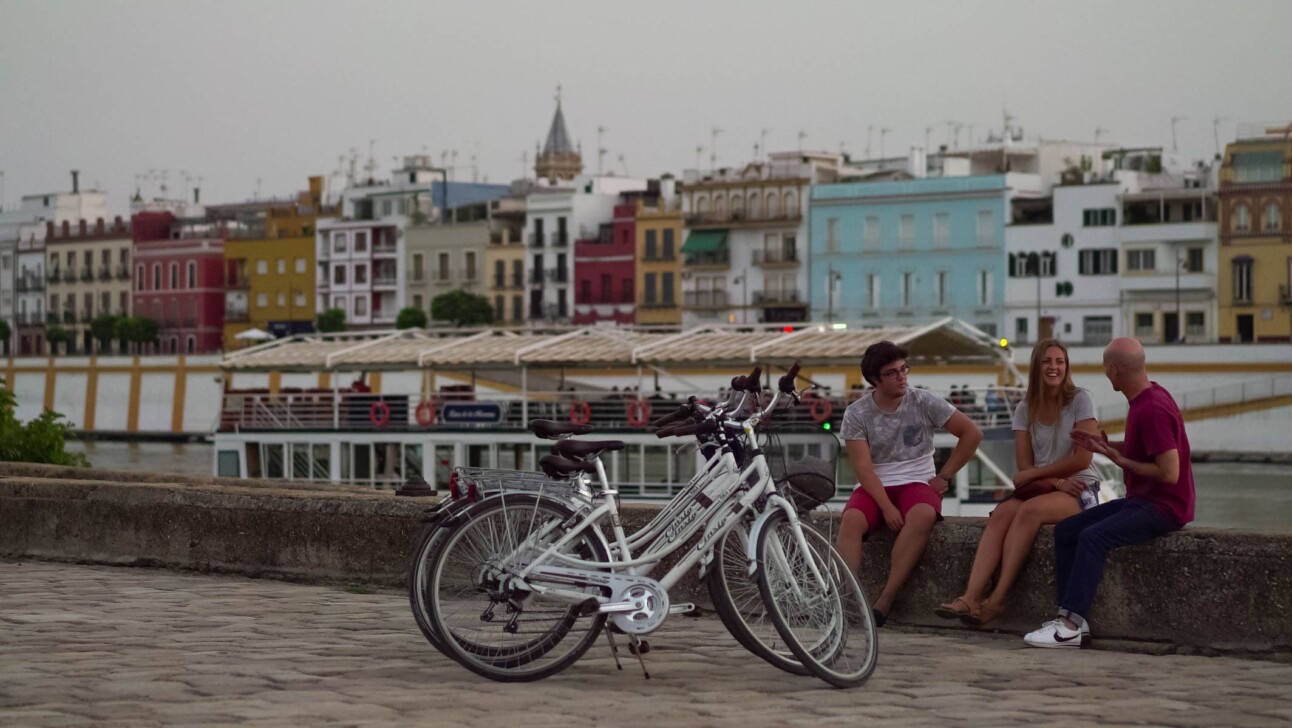 bikers enjoy a sunset along the river in seville