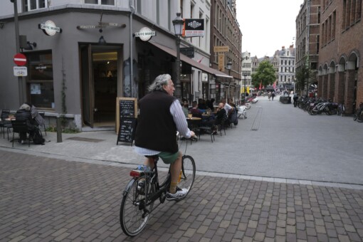 A man riding his bike through the town of Antwerp, Belgium