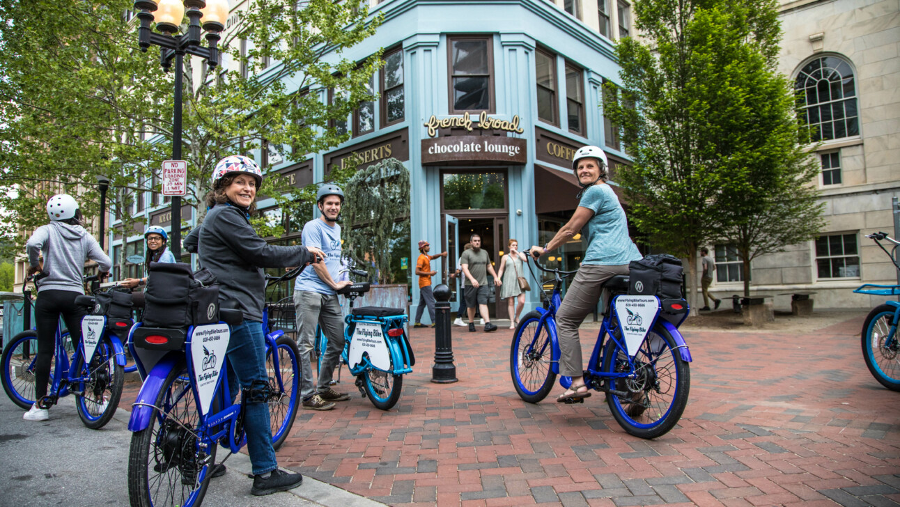 A group of cyclists stop outside the French Bread Chocolate Lounge in Asheville, North Carolina