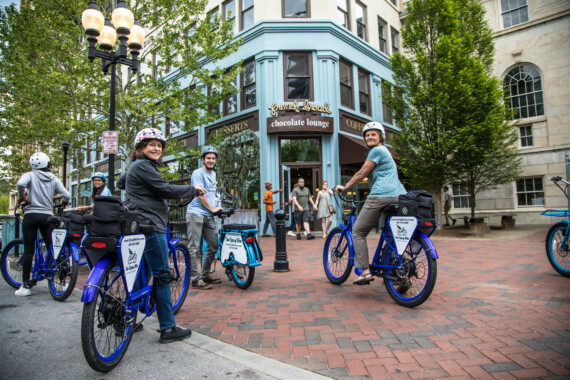 A group of cyclists stop outside the French Bread Chocolate Lounge in Asheville, North Carolina