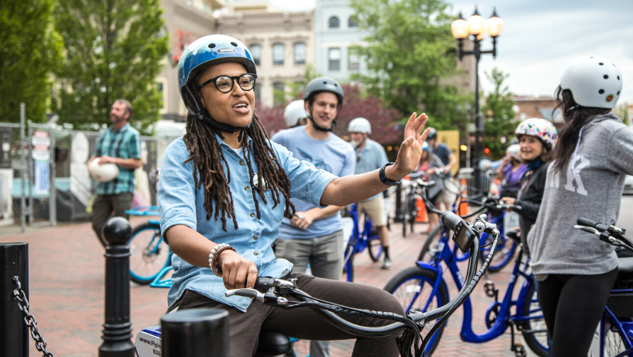 A group of cyclists stop in Packsquare Park in Asheville, North Carolina