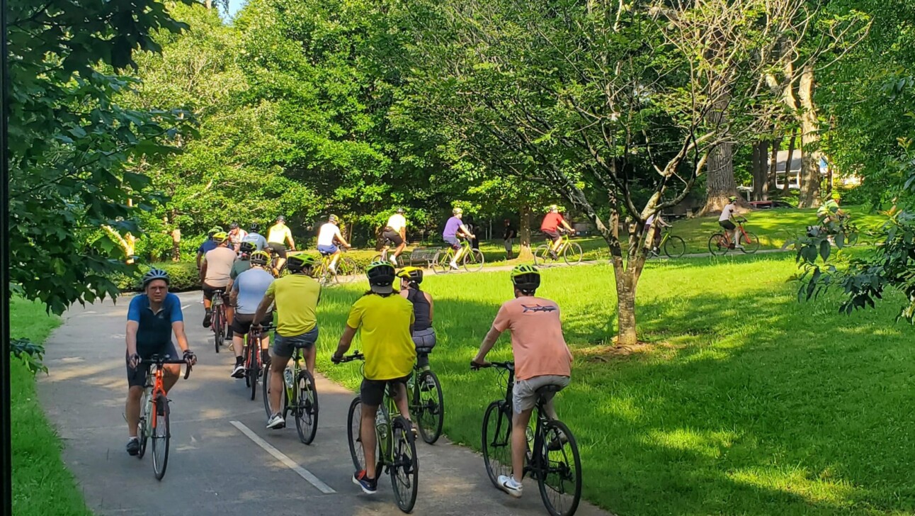A group of cyclists ride through Inman Park in Atlanta, Georgia