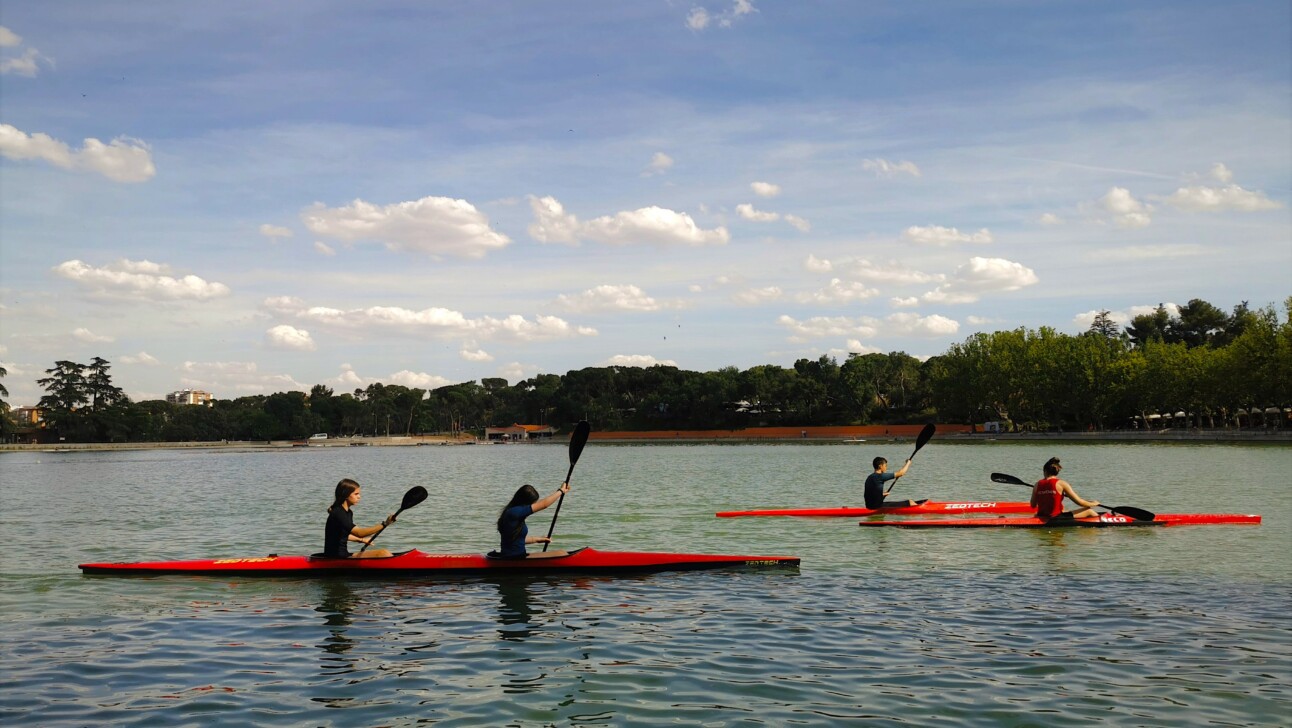 Kayakers paddle through Casa de Campo Parklands in Madrid, Spain