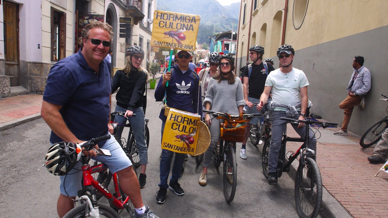 A man selling ants to eat crosses the bike tour in Bogota, Colombia