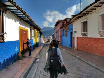 A women walks through the colorful Candelaria neighborhood in Bogota, Colombia