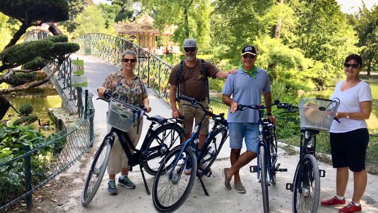 Cyclists stop to pose for a photo in the Jardin Public in Bordeaux, France
