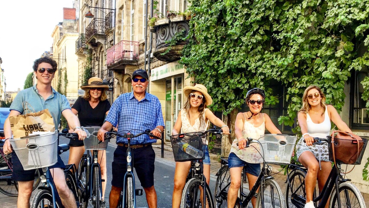 A group of cyclists pose for a photo on Rue de Notre Dame in Bordeaux, France