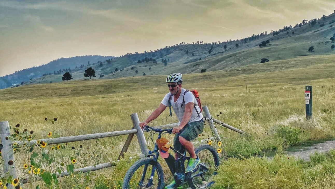 A man rides his bike along Boulder Creek Path