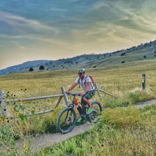 A man rides his bike along Boulder Creek Path