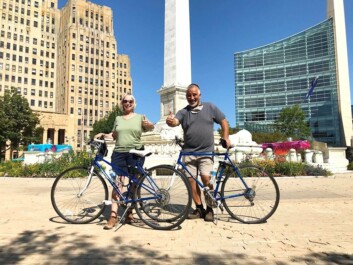 A couple poses for a photo with their bikes in front of the McKinley Monument in Buffalo, New York