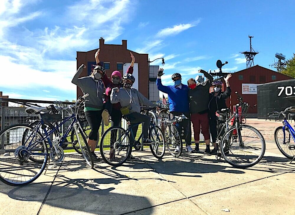 A group of cyclists pose for a photo at the Buffalo waterfront