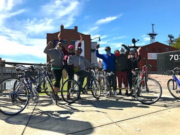 A group of cyclists pose for a photo at the Buffalo waterfront