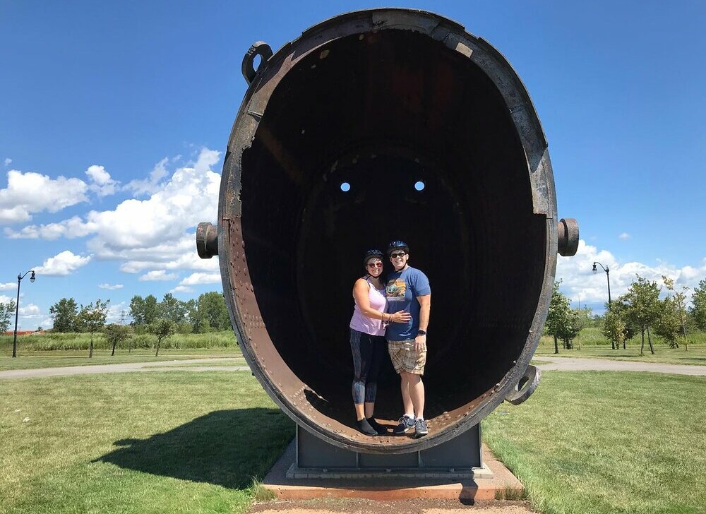 A couple stands inside the Giant Molten Iron Ladle in Buffalo, New York