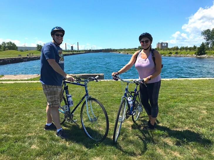 A couple poses with their bikes along the Buffalo waterfront