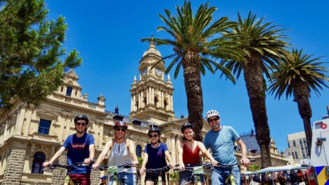 A group of cyclists in front of the Cape Town city hall