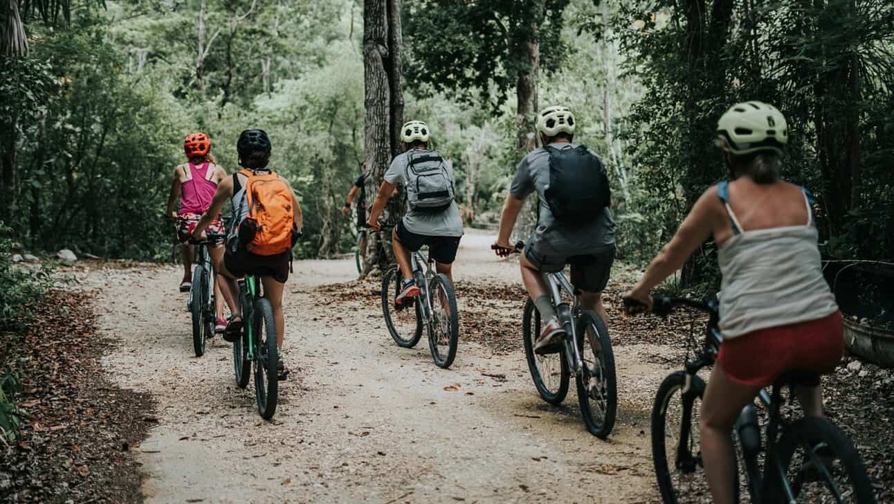 a group biking through the forest in Tulum, Mexico