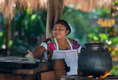 A woman making breakfast in the jungle