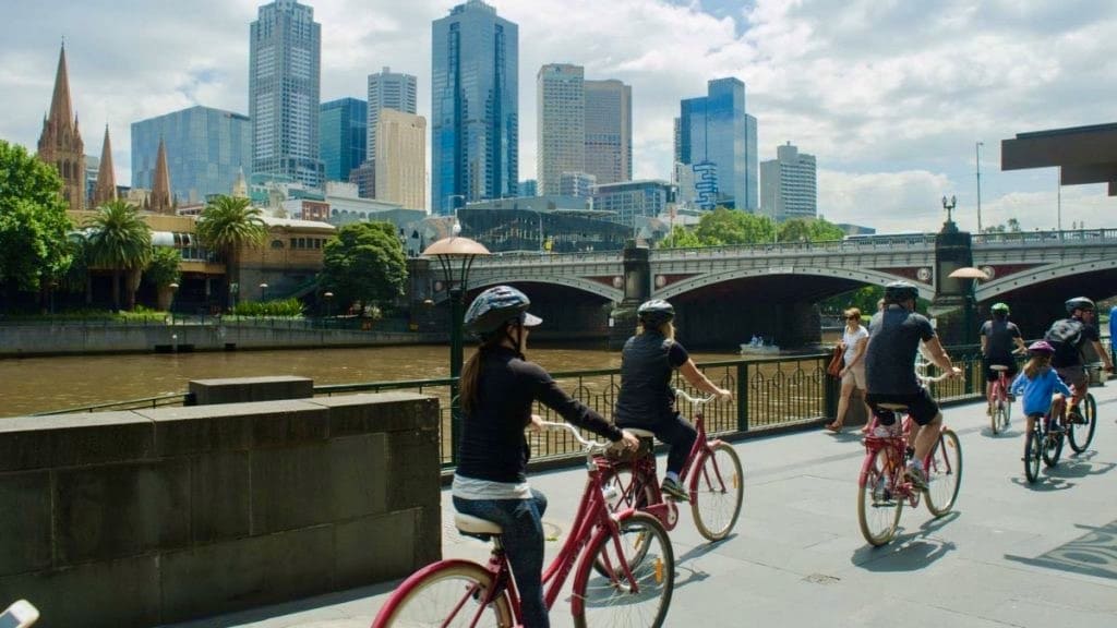 Cyclists ride along the Yarra River in Melbourne, Australia