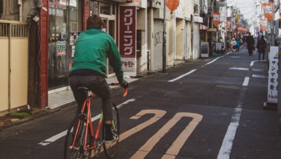 a man riding a road bike through Tokyo