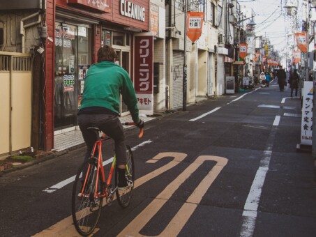 a man riding a road bike through Tokyo