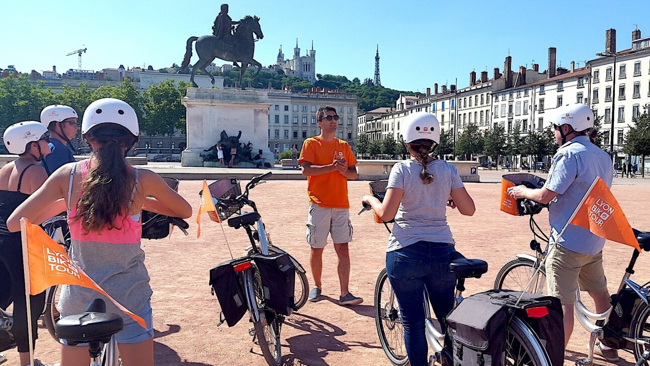 Cyclists in Place Bellecour in Lyon, France