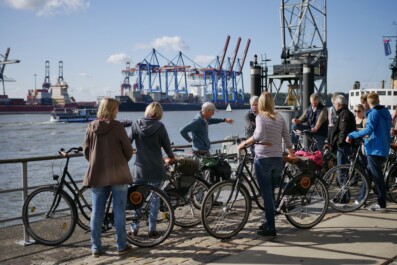 A group of cyclists along the river in Hamburg, Germany