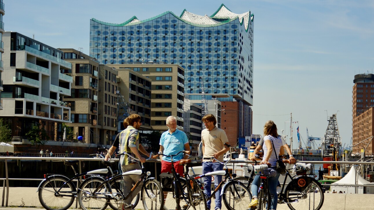 A group of cyclists stop to hear about Hafencity in Hamburg, Germany