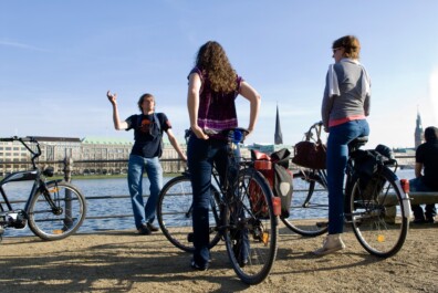 A group of cyclists along the water in Hamburg, Germany