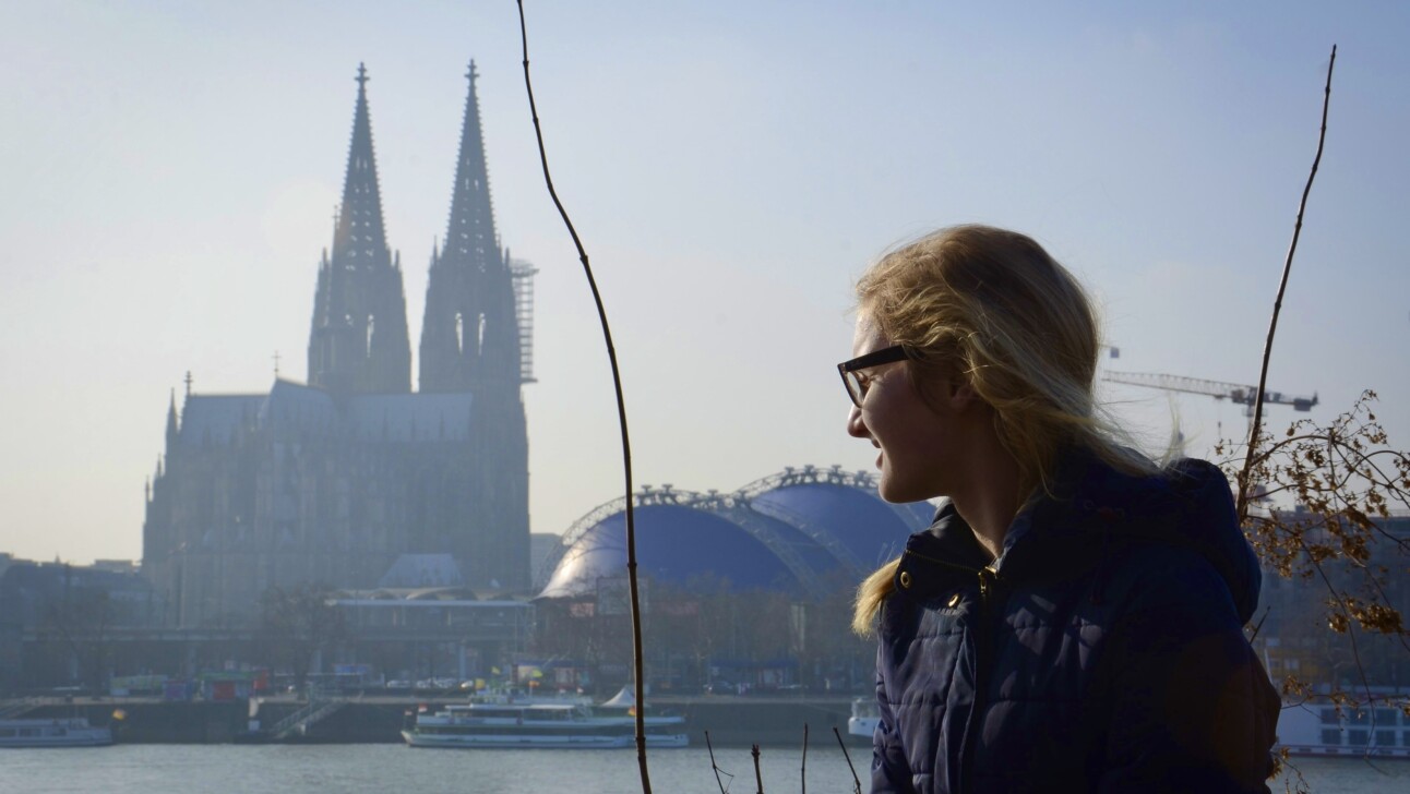 A women looks over the Rhine River in Cologne, Germany