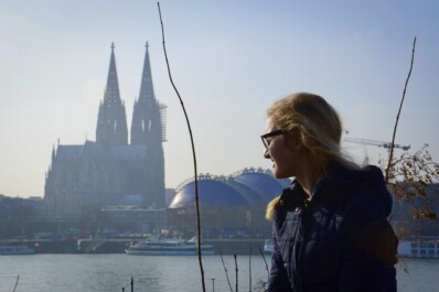 A women looks over the Rhine River in Cologne, Germany