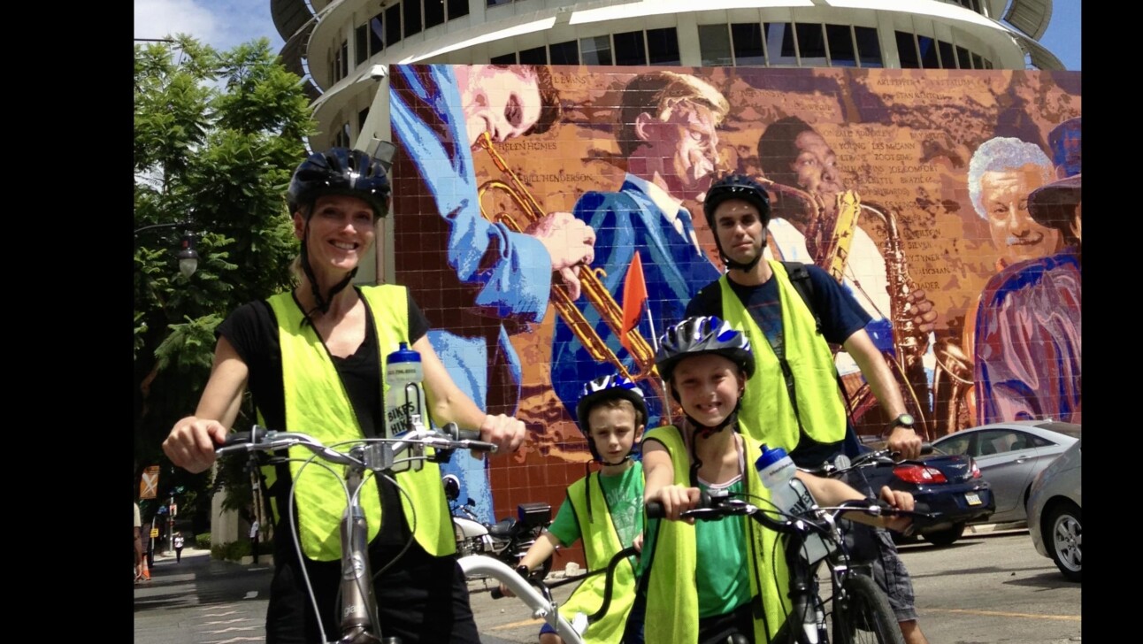 A family on bicycles in front of Capitol Records in Hollywood, California