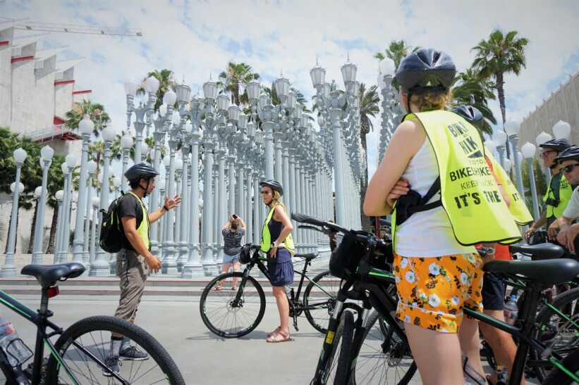 Cyclists stop to hear about the Los Angeles County Museum of Art