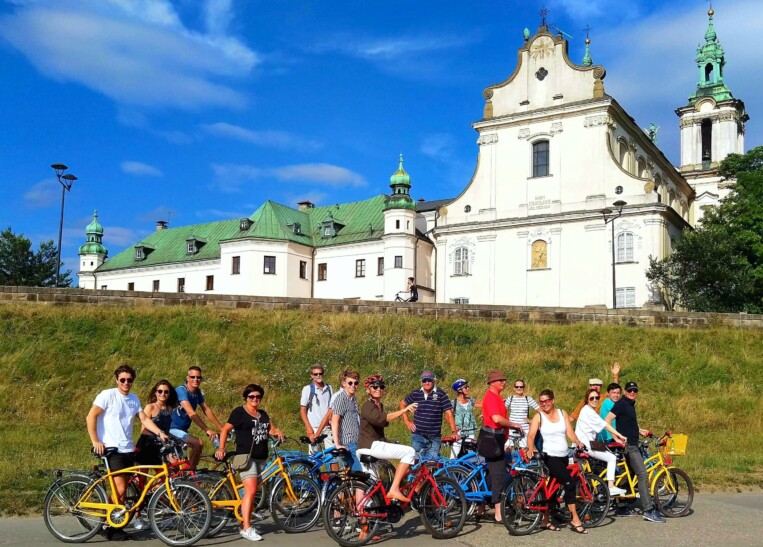 A group of cyclists in front of St. Anne's Church in Krakow, Poland
