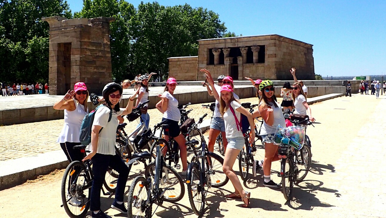 Cyclists pose for a photo in front of the Alegria Debod Temple in Madrid, Spain