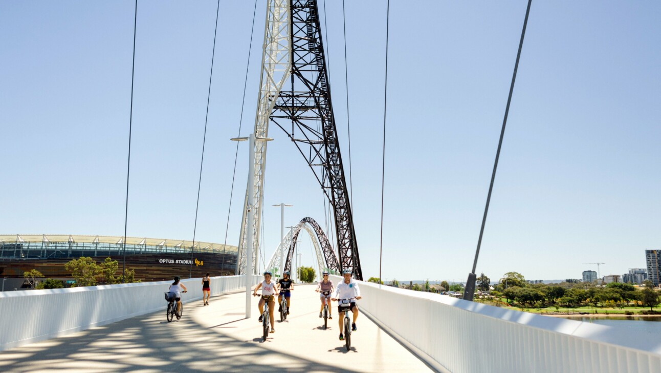 Cyclists ride across the Matagarup bridge in Perth, Australia