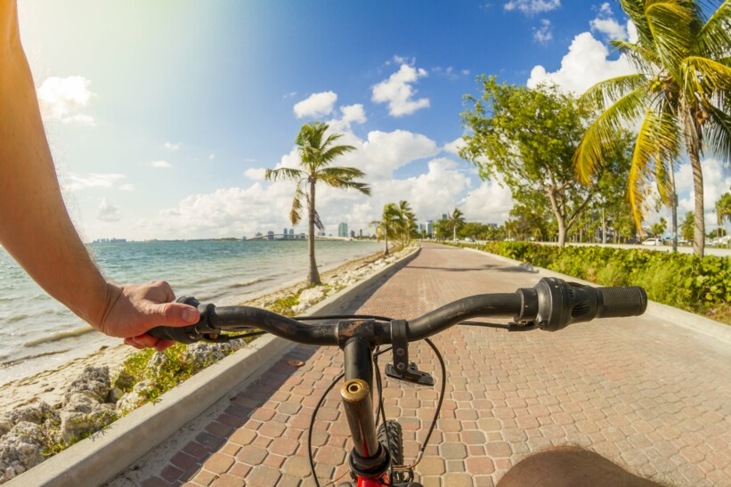 A view of the Miami Boardwalk from the handlebars of a bicycle