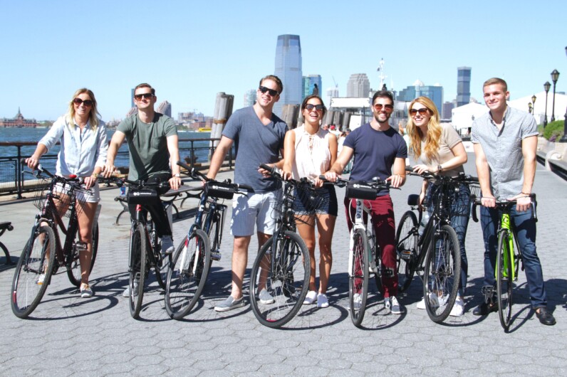 a group of cyclists pose with their bikes in New York City