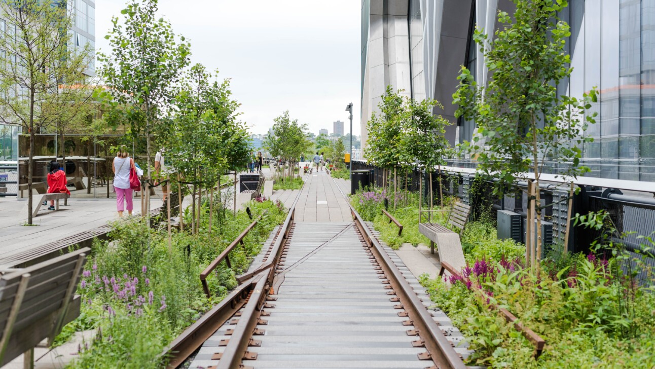 An old railroad track runs through the Highline green space in New York City