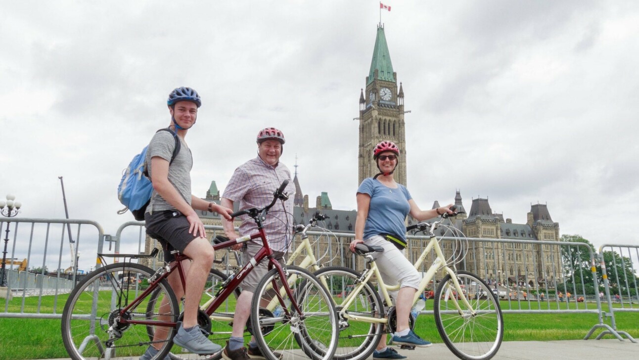 Cyclists in front of the Parliament building in Ottawa, Canada