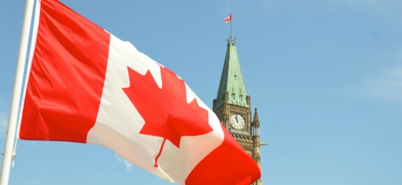 The Canadian flag in front of the Parliament Tower in Ottawa, Canada