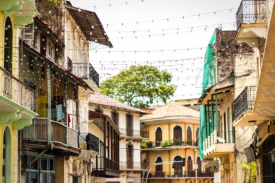 String lights connected between colorful homes in Panama City