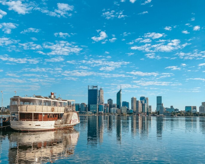 A view of Perth, Australia from the water with a large boat in the picture