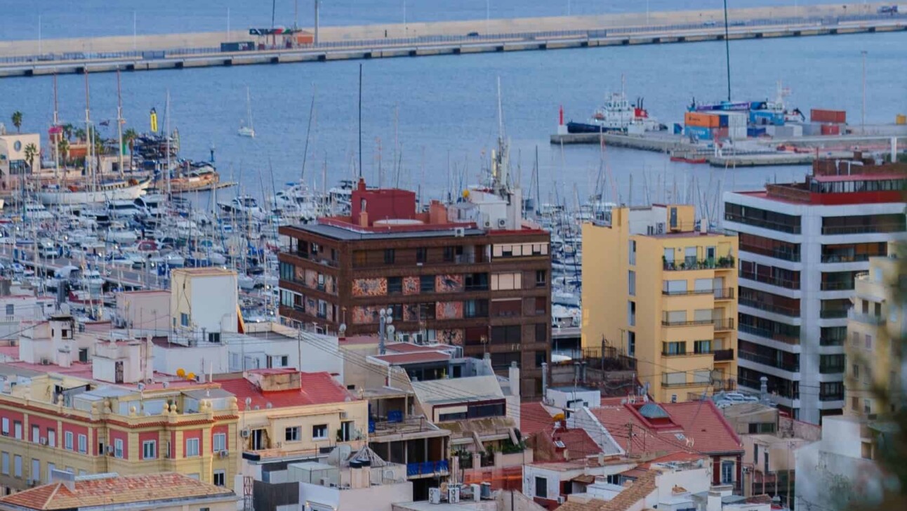 People sitting atop the city of Alicante looking out over the Marina