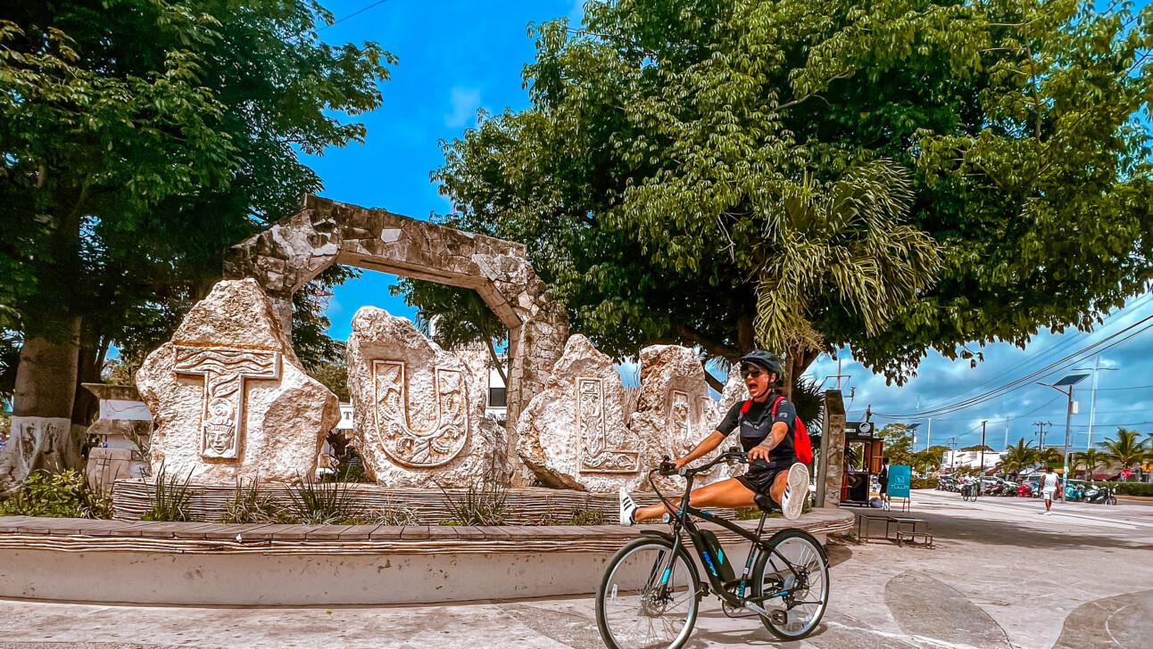 A man riding a bike through Tulum, Mexico